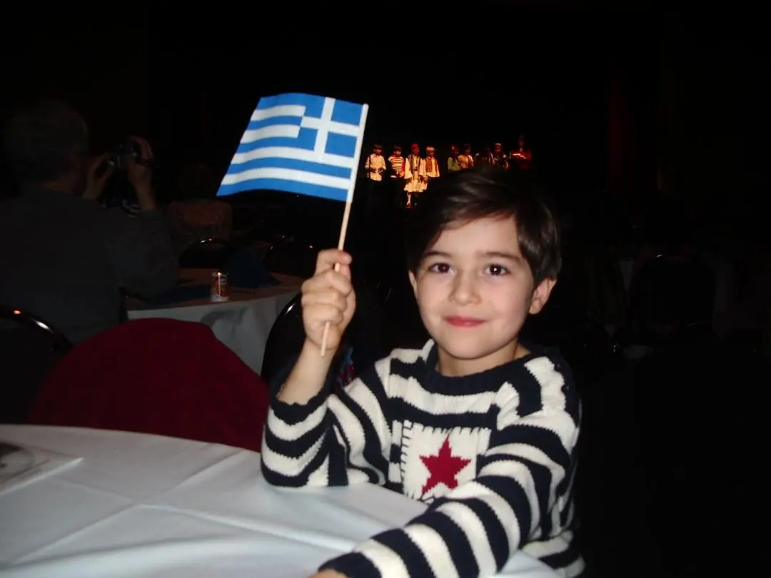 Child waving the Greek flag