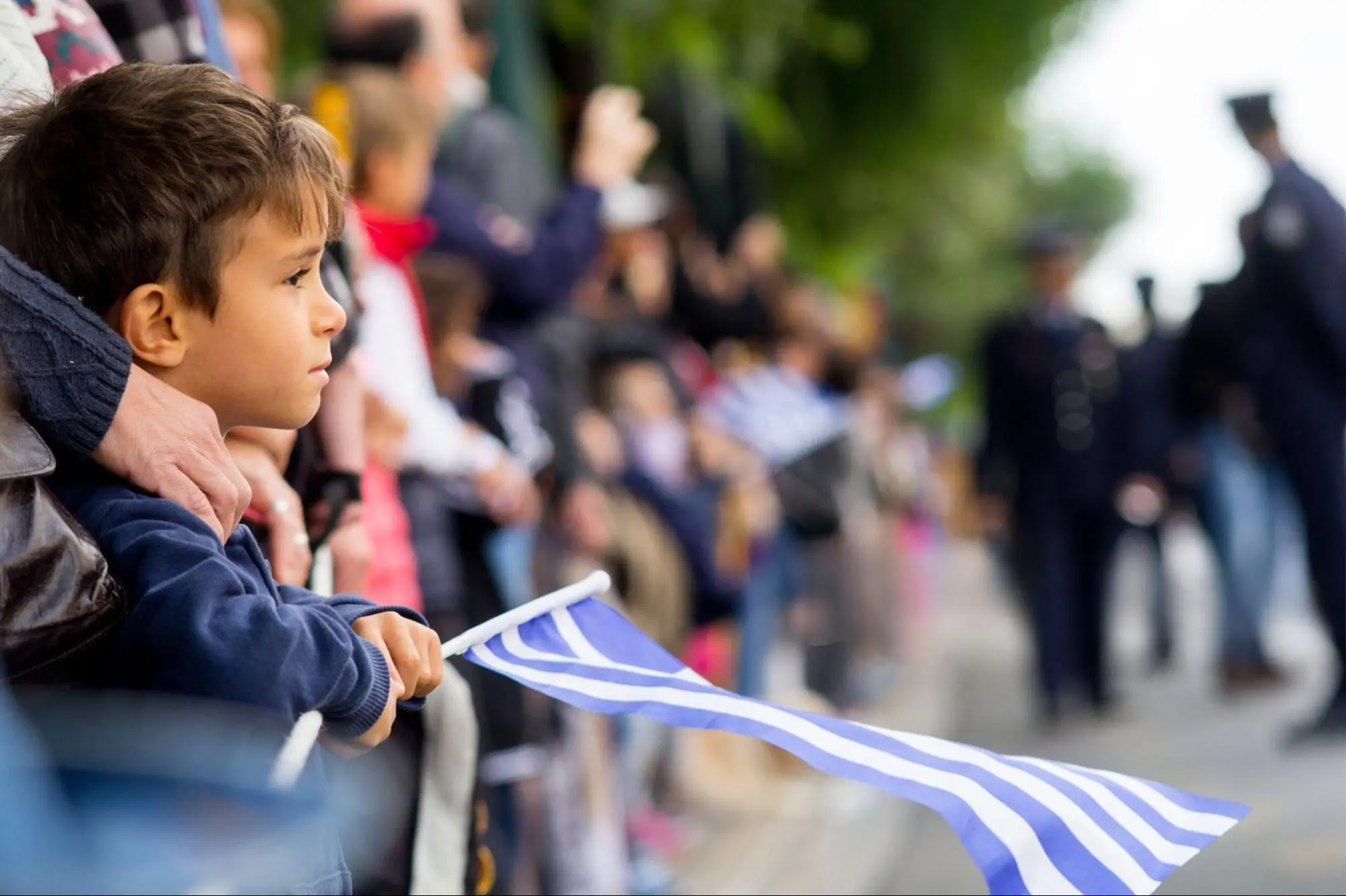 Child Holding Greek Flag At Parade